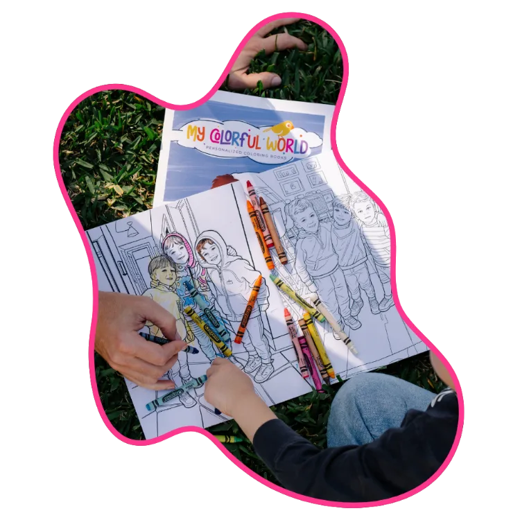 Hands coloring an open personalized coloring book with crayons outdoors