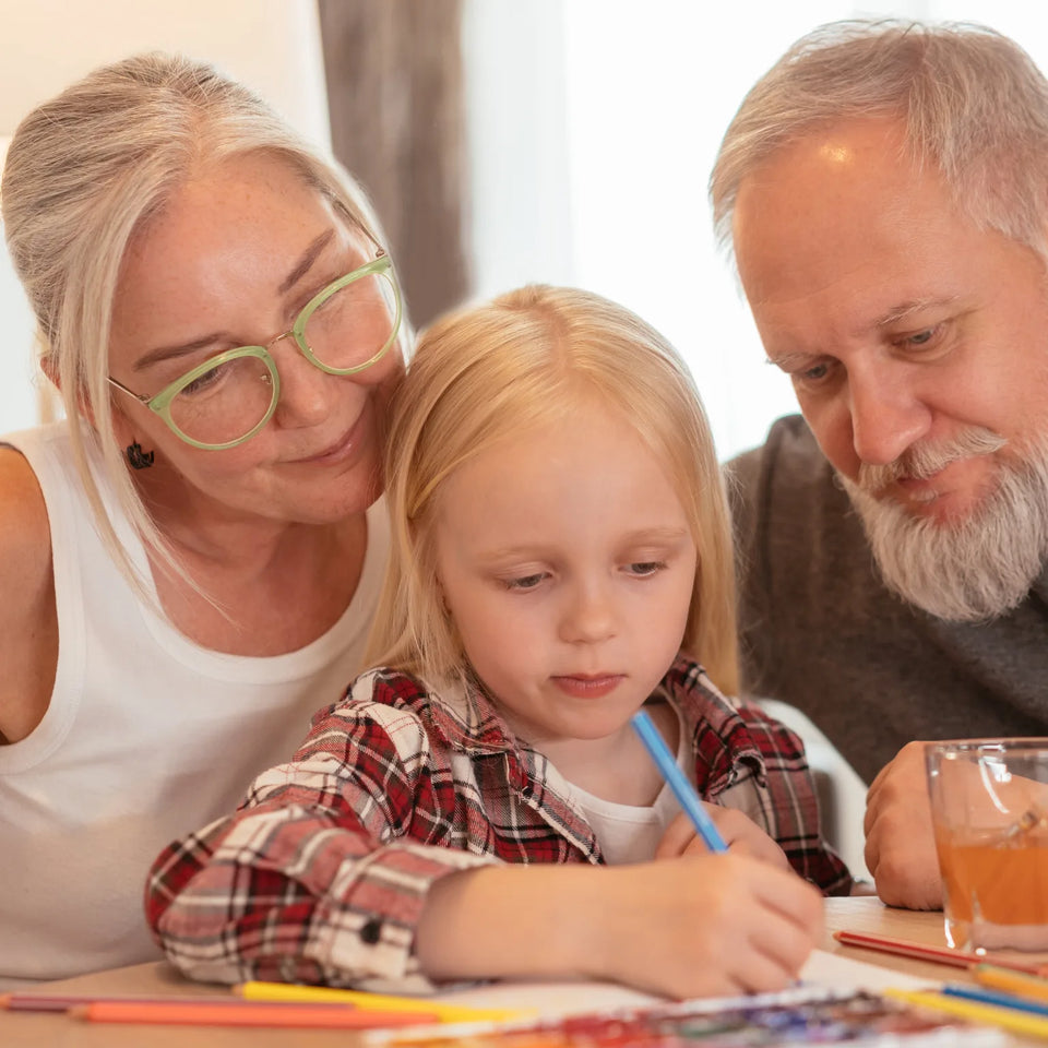 Grandparents and a young girl coloring a personalized coloring book together
