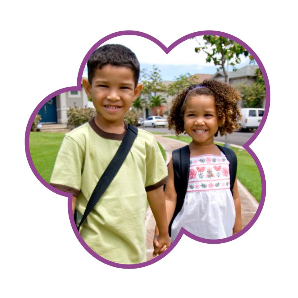 Two children with backpacks on the way to school