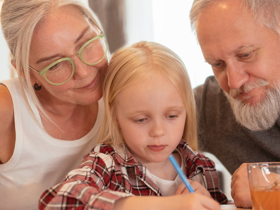Grandparents coloring a personalized coloring book with their grandchild