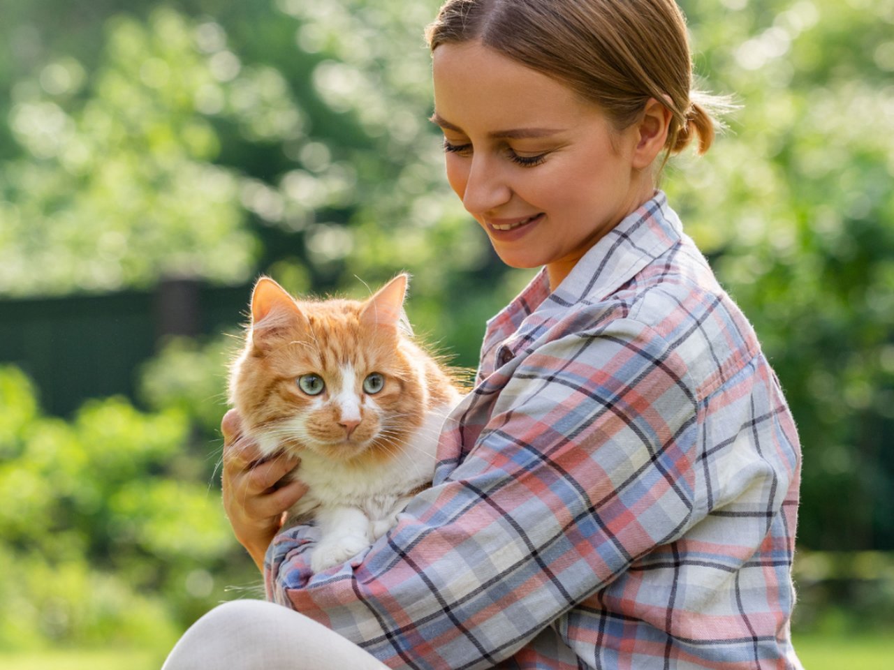 Pet lover holding a cat beside a personalized pet coloring book